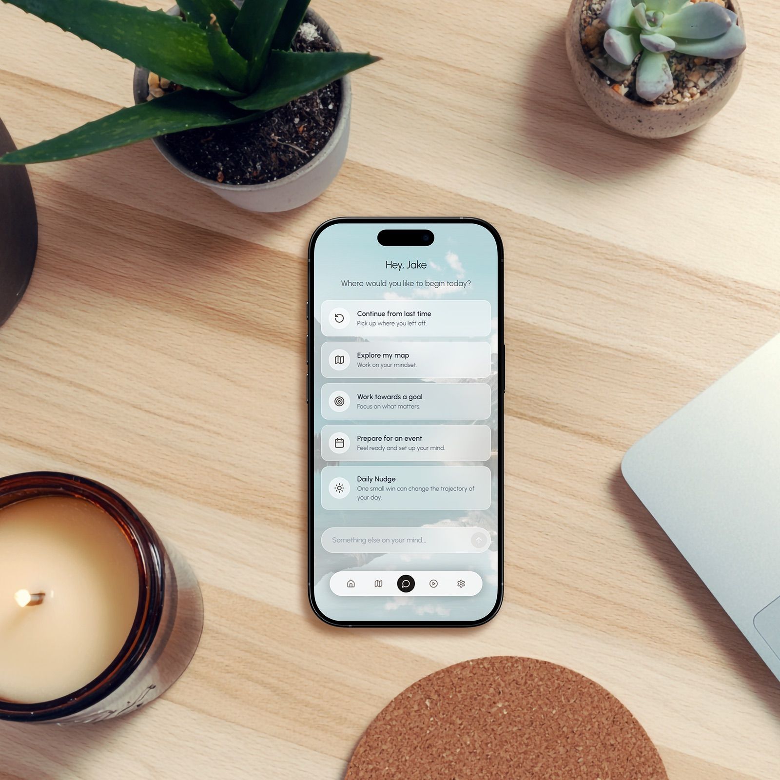 Smartphone on a desk showing the MindsetOS coaching app